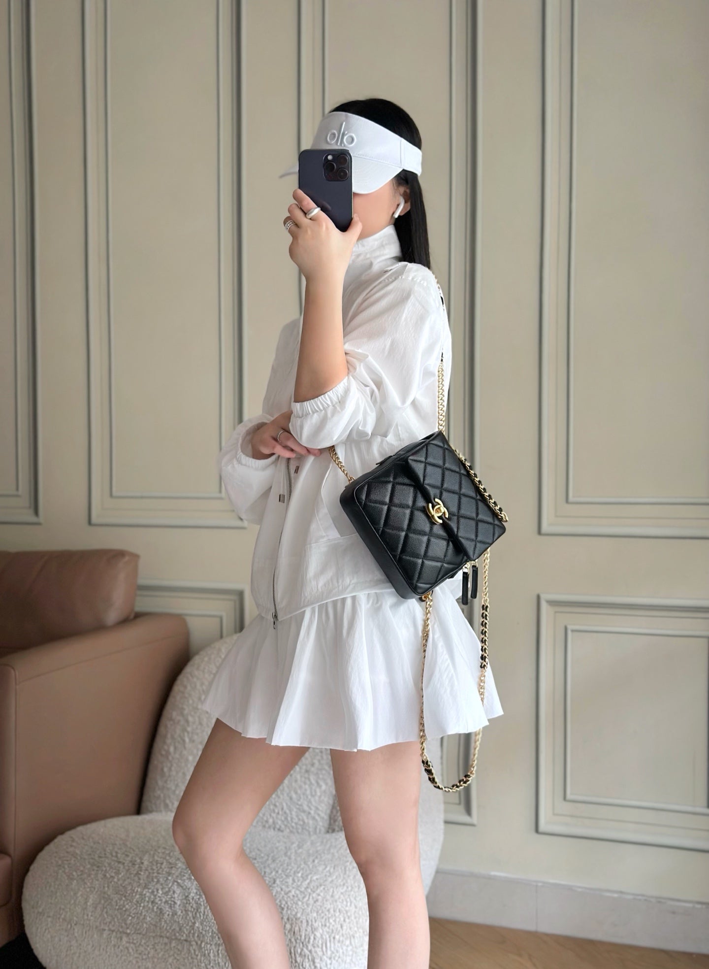 Chanel quilted mini shoulder bag, black with gold chain strap and CC clasp on model