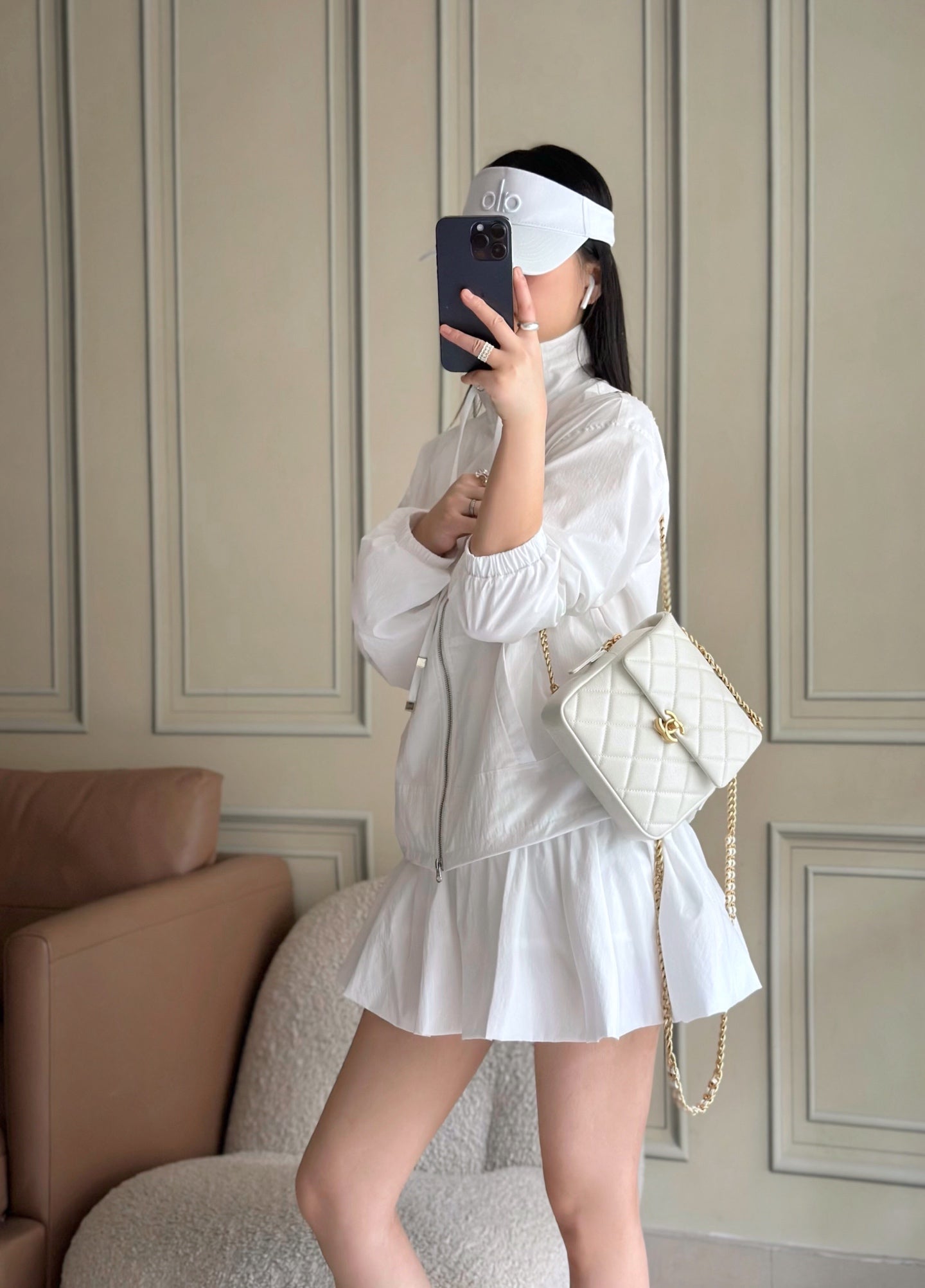 Chanel quilted mini bag in white worn crossbody with gold chain strap and flap