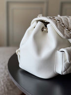Chanel white leather bucket bag with front snap and silver chain strap