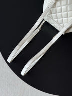 Chanel white leather bucket bag with two strap handles and side seam
