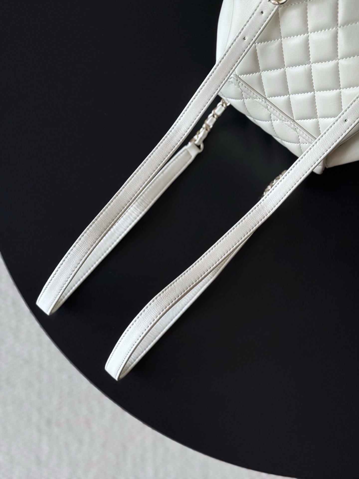 Chanel white leather bucket bag with two strap handles and side seam