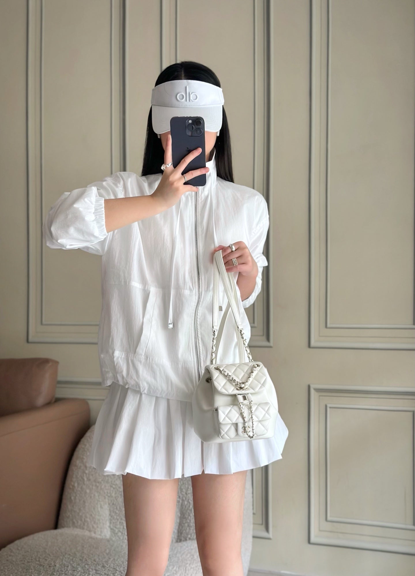 Chanel white quilted mini bucket bag with chain strap worn crossbody