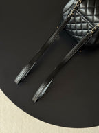 Chanel leather wrist strap with gold chain accents for quilted mini bag