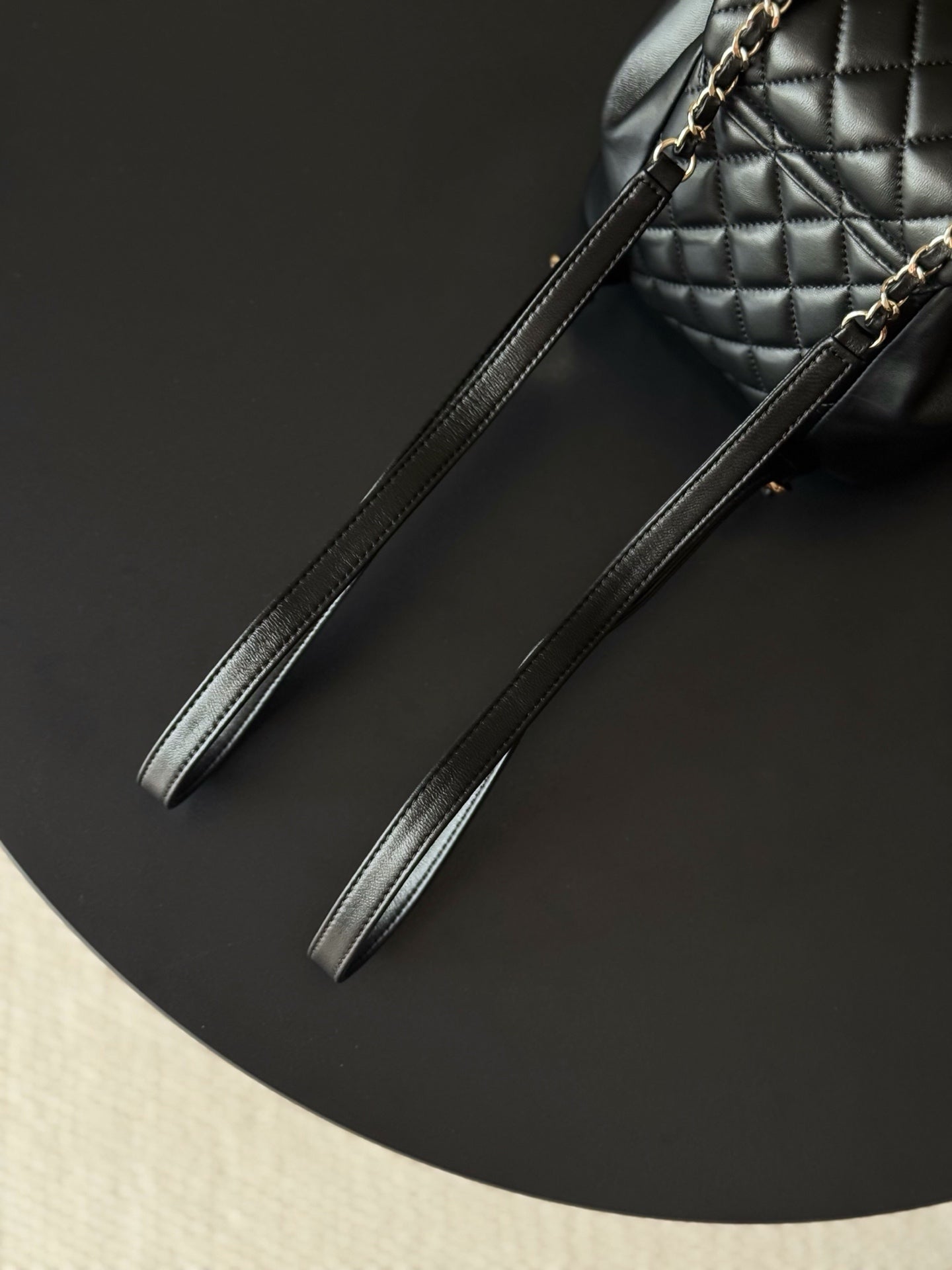 Chanel leather wrist strap with gold chain accents for quilted mini bag