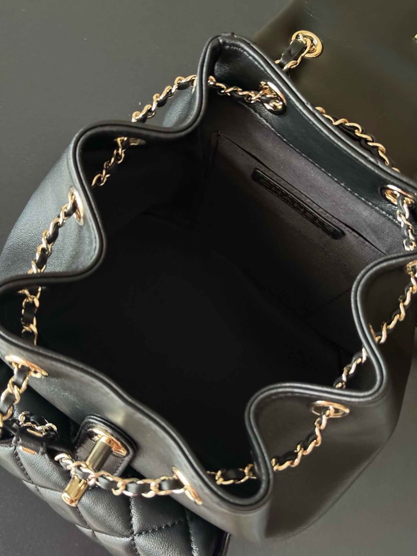 Chanel quilted leather mini bag open interior with chain shoulder strap