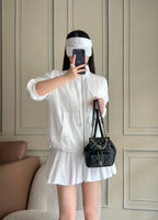 Chanel quilted mini shoulder bag worn with chain strap by person