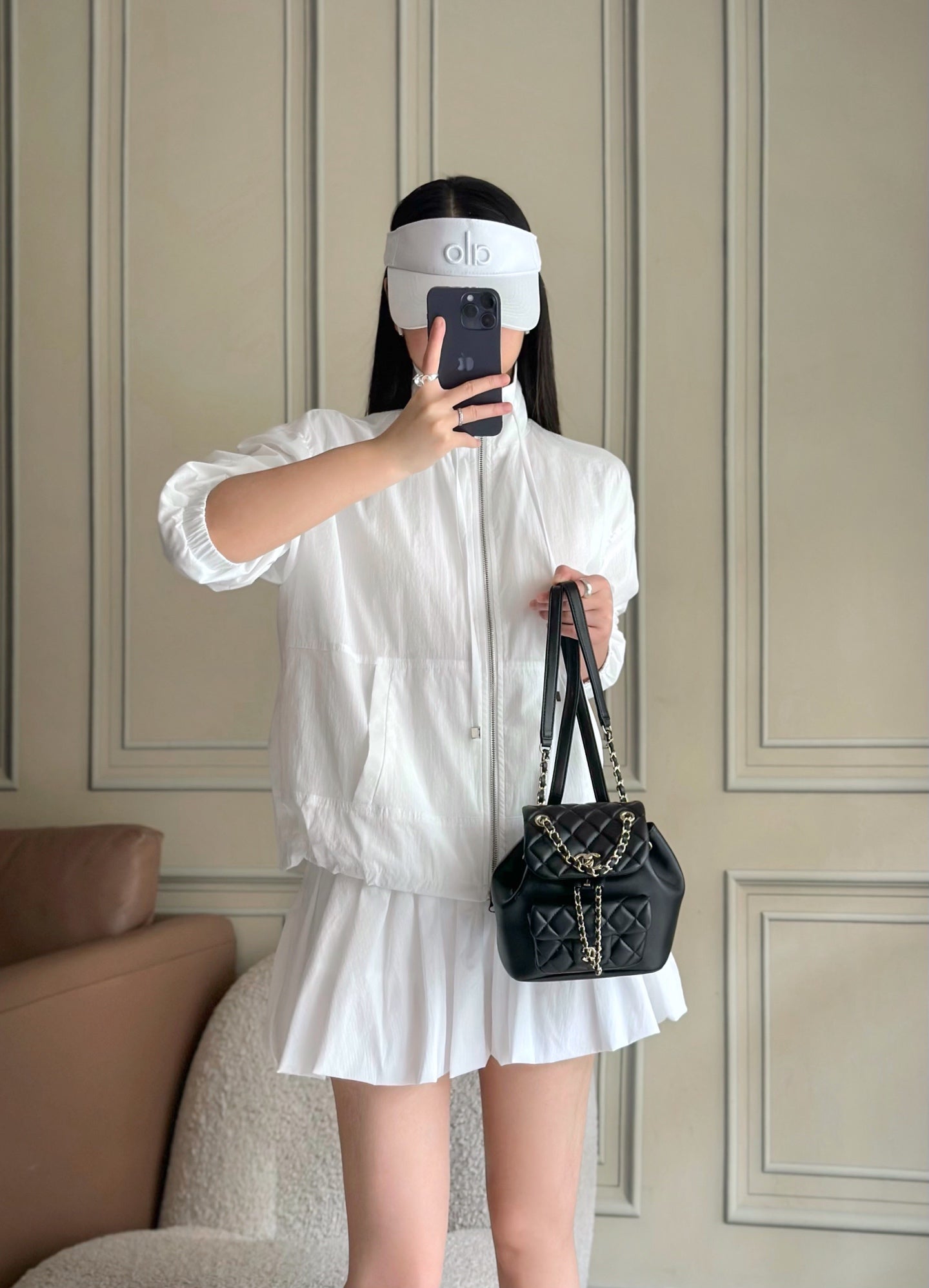 Chanel quilted mini shoulder bag worn with chain strap by person
