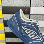 Blue unisex sneakers with white midsoles, lace-up front, and BALENCIAGA branding