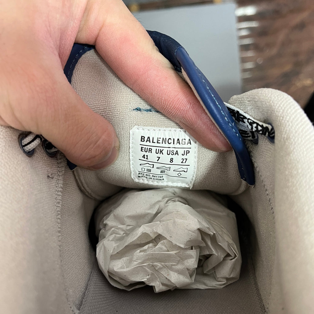 Inside sneaker label with Balenciaga branding and size info on white lining