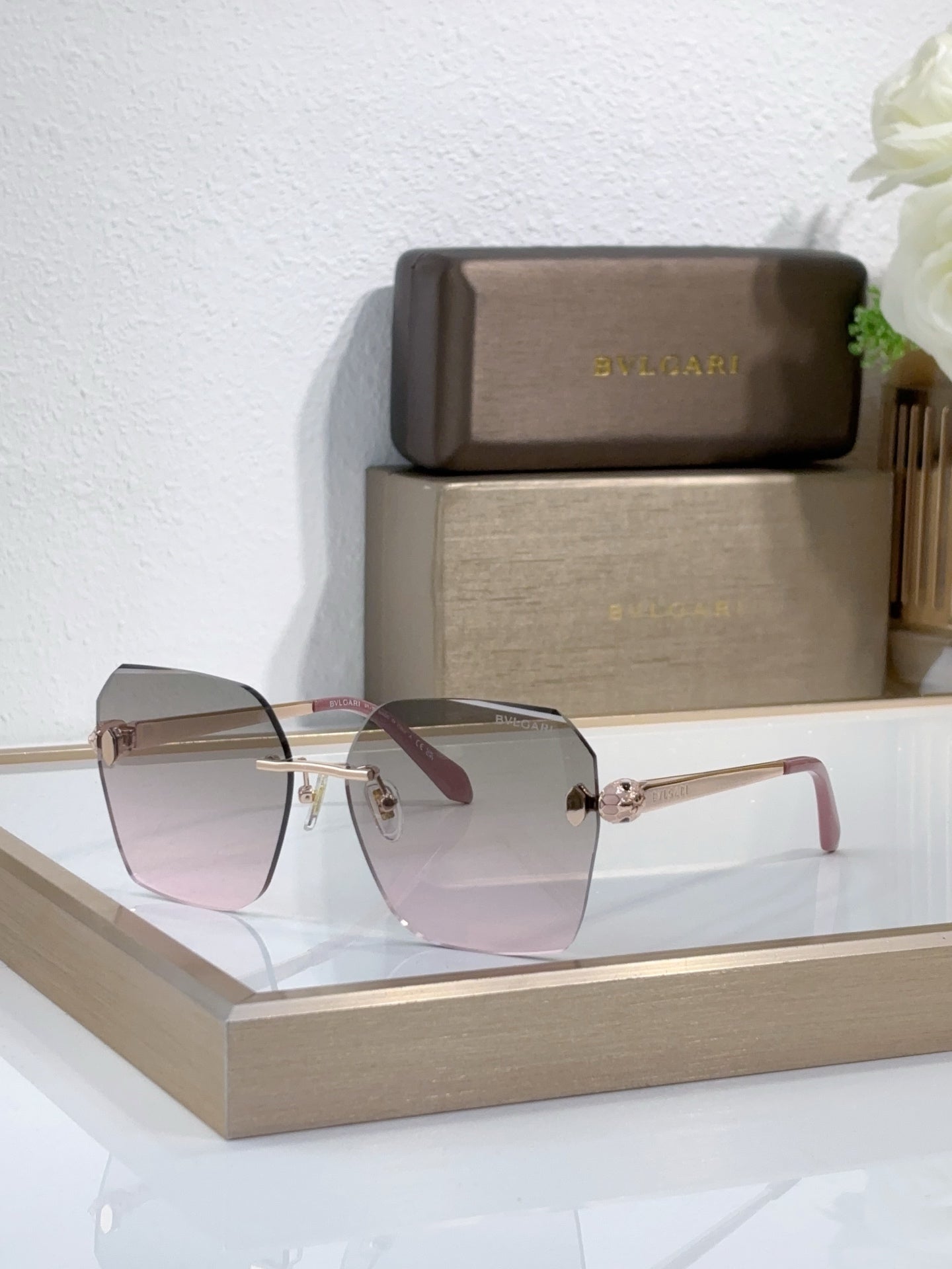 Bvlgari sunglasses with pink tinted gradient lenses and gold-tone metal frame