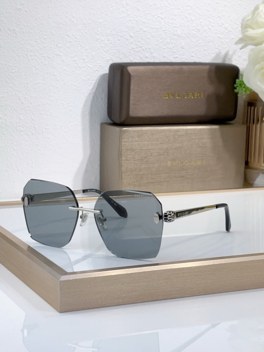 Bvlgari sunglasses with dark blue gradient lenses and gold-tone metal frame