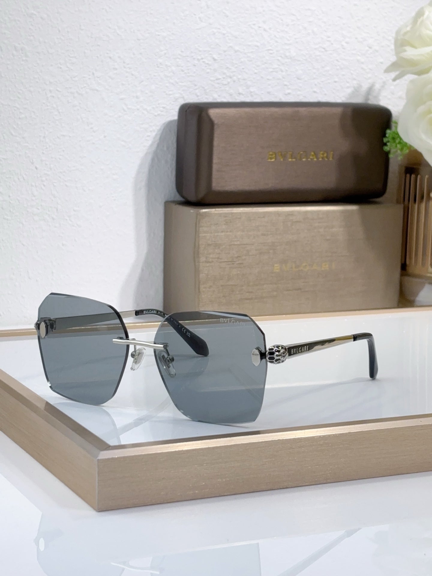 Bvlgari sunglasses with dark blue gradient lenses and gold-tone metal frame