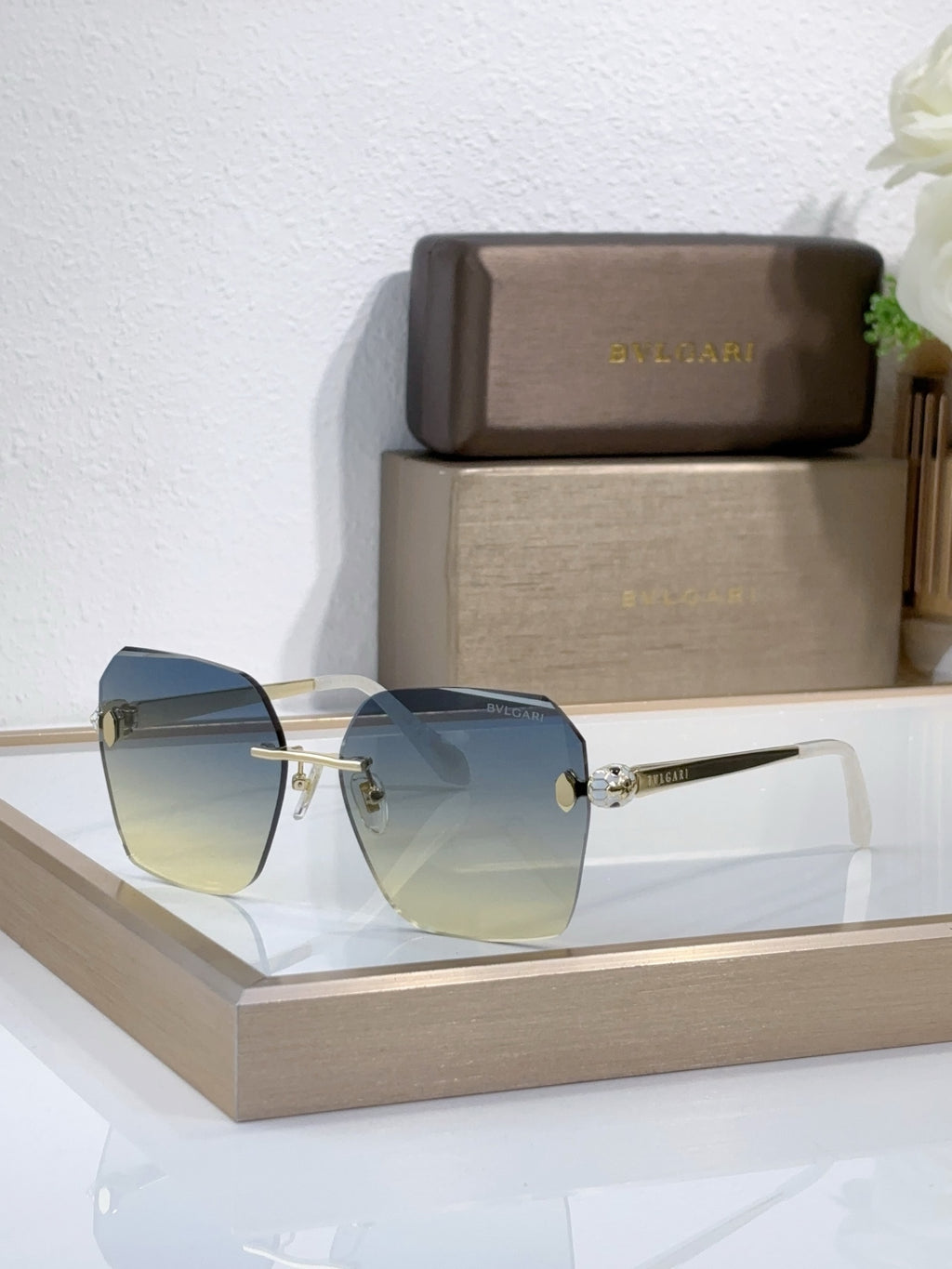 Bvlgari sunglasses with light blue gradient lenses and gold-tone metal frame