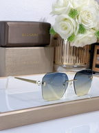 Bvlgari sunglasses with blue gradient lenses and gold-tone metal frame, side angle