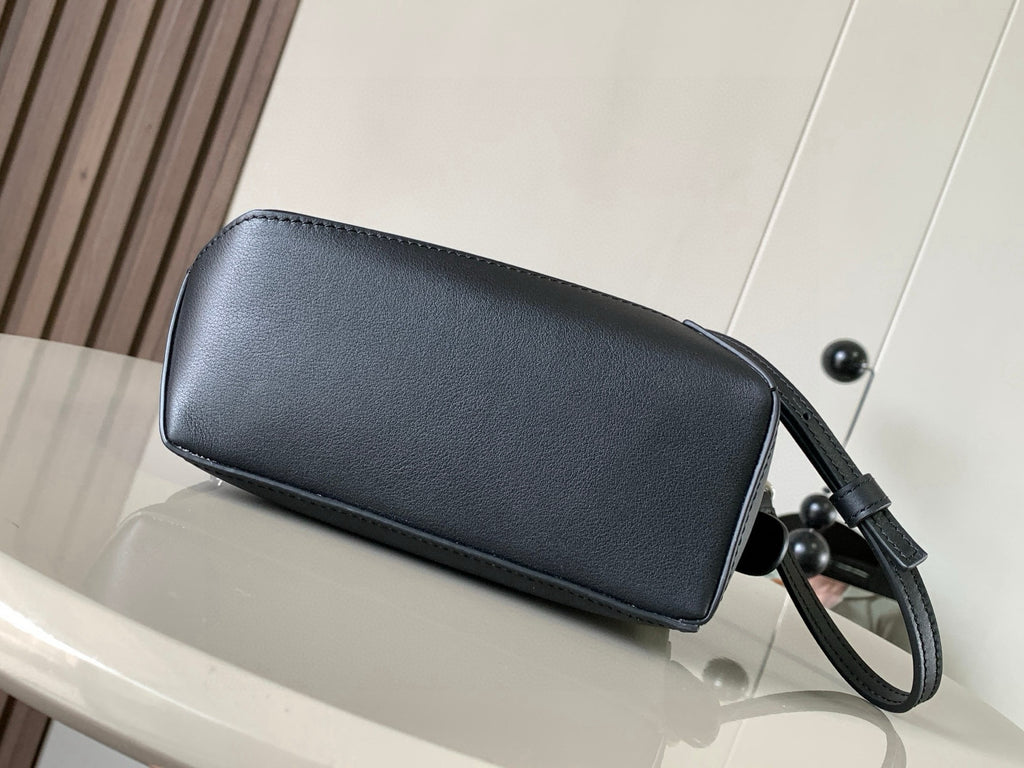 Loewe navy leather wristlet bag with top handle strap and curved silhouette