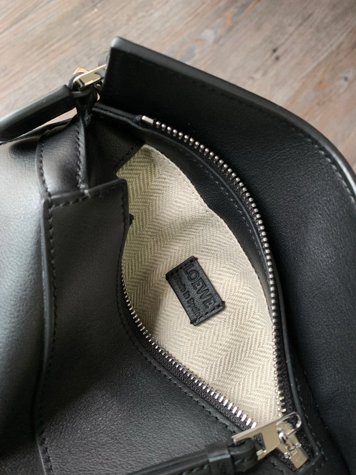 Loewe navy leather bag interior zipper and Loewe fabric logo patch