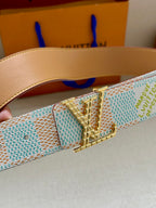 Louis Vuitton belt buckle close-up on turquoise-and-white patterned strap