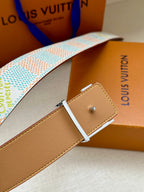 Louis Vuitton belt with tan leather end and silver buckle pin on patterned strap