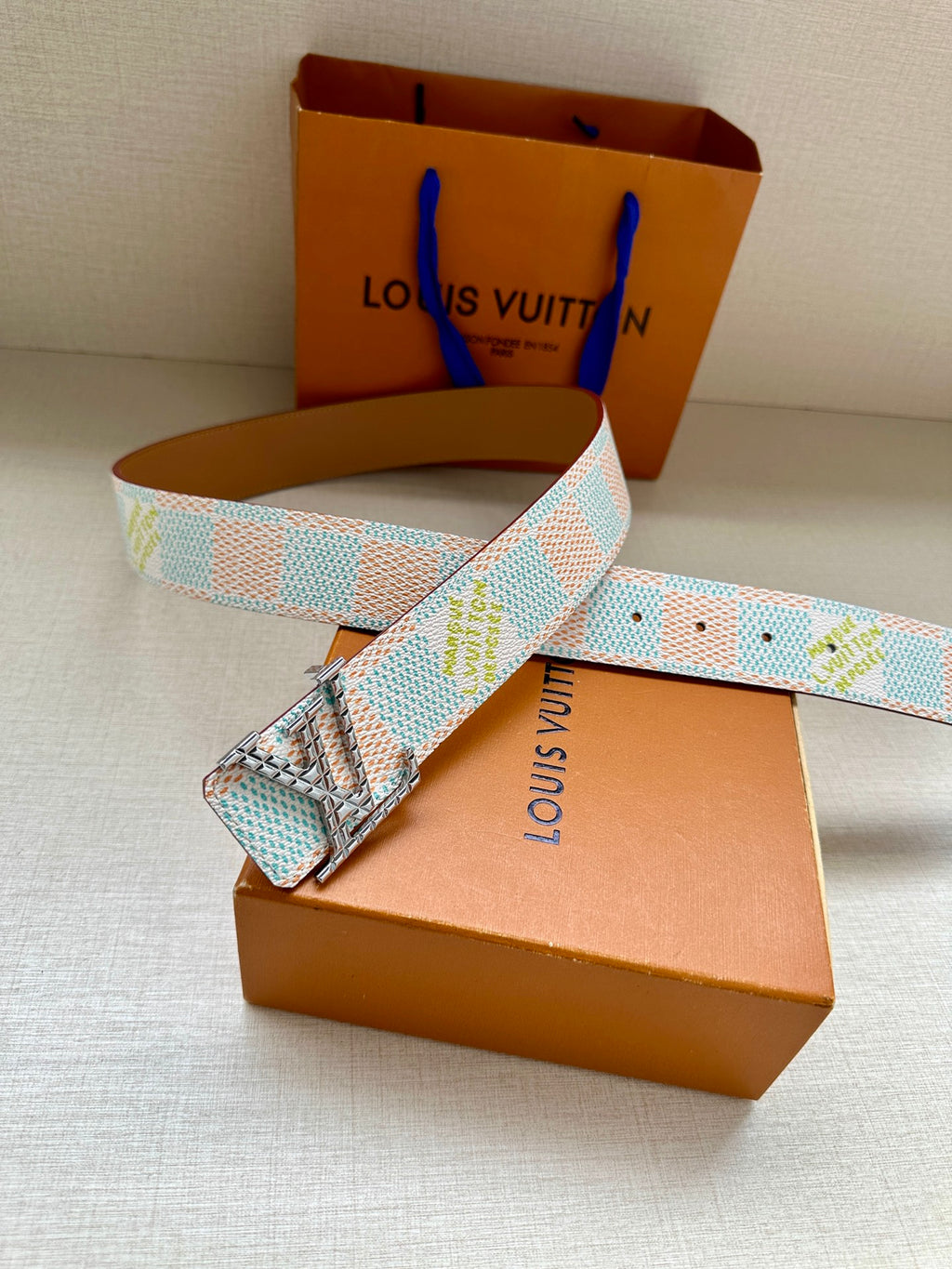 Louis Vuitton belt with turquoise-and-white patterned strap and gold-tone buckle