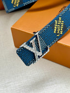 Blue patterned Louis Vuitton belt with silver buckle and engraved hardware close-up