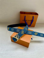 Blue patterned Louis Vuitton belt with large silver LV buckle, shown laid across