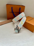 Louis Vuitton canvas belt with light blue and white pattern and silver buckle.