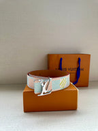 Louis Vuitton canvas belt with light blue and white patterned strap and silver buckle.