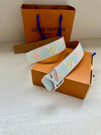 Louis Vuitton belt with light blue and white canvas pattern and silver buckle.