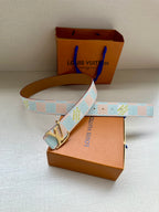 Louis Vuitton belt with light blue and white pattern strap and silver buckle, tan edge.