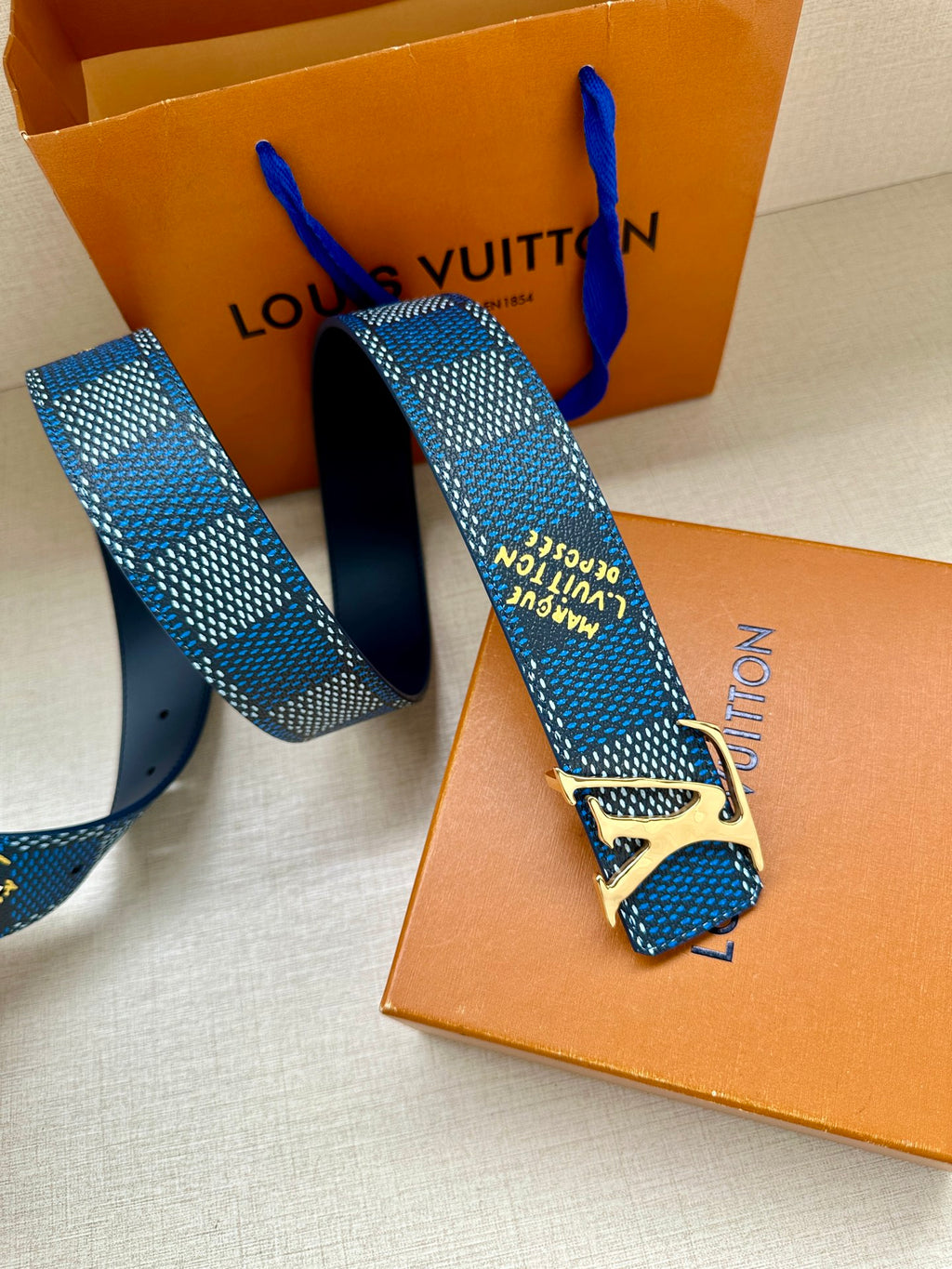 Louis Vuitton belt with blue check pattern and gold buckle, end with holes