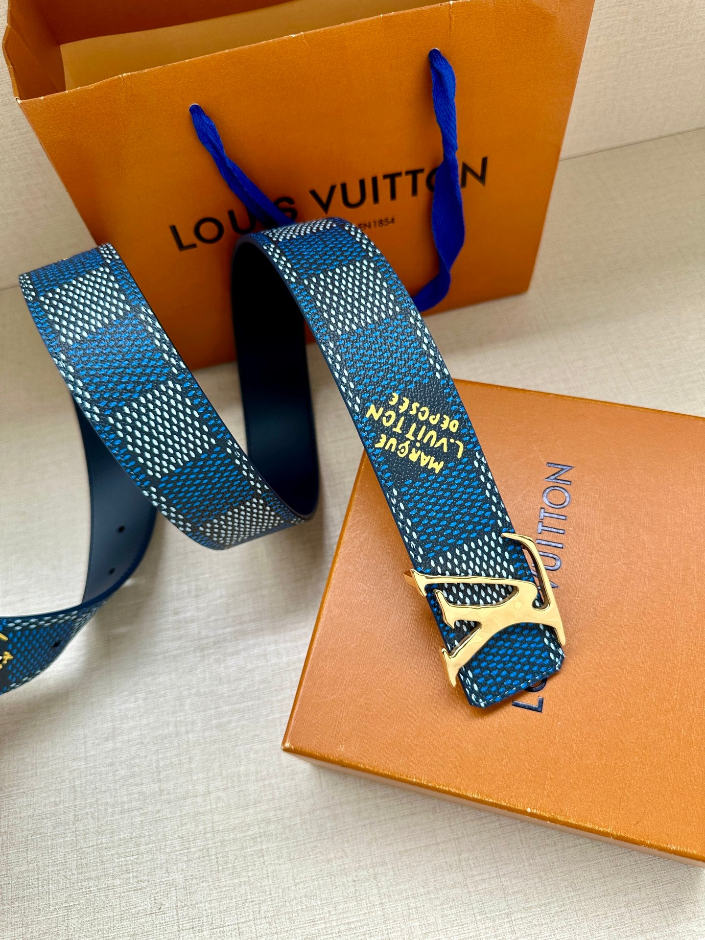 Louis Vuitton belt with blue check pattern and gold buckle, end with holes