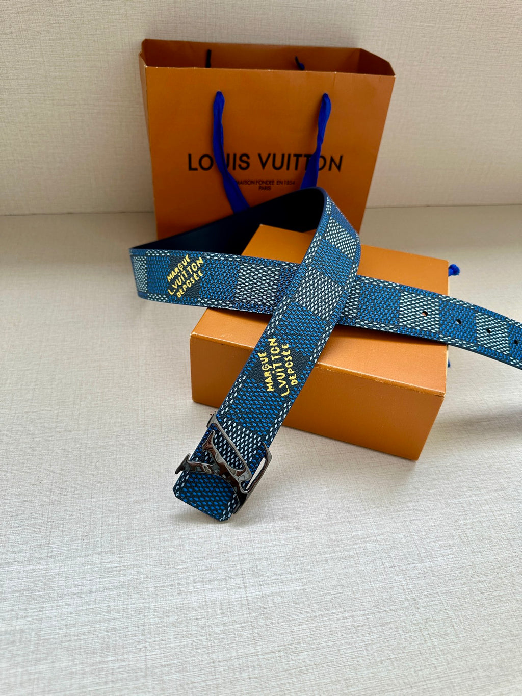 Louis Vuitton belt with blue check webbing and gold-tone LV buckle and strap end