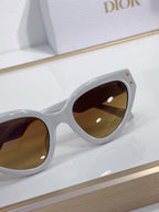 Bvlgari cat-eye sunglasses close-up with white frames and brown tinted lenses