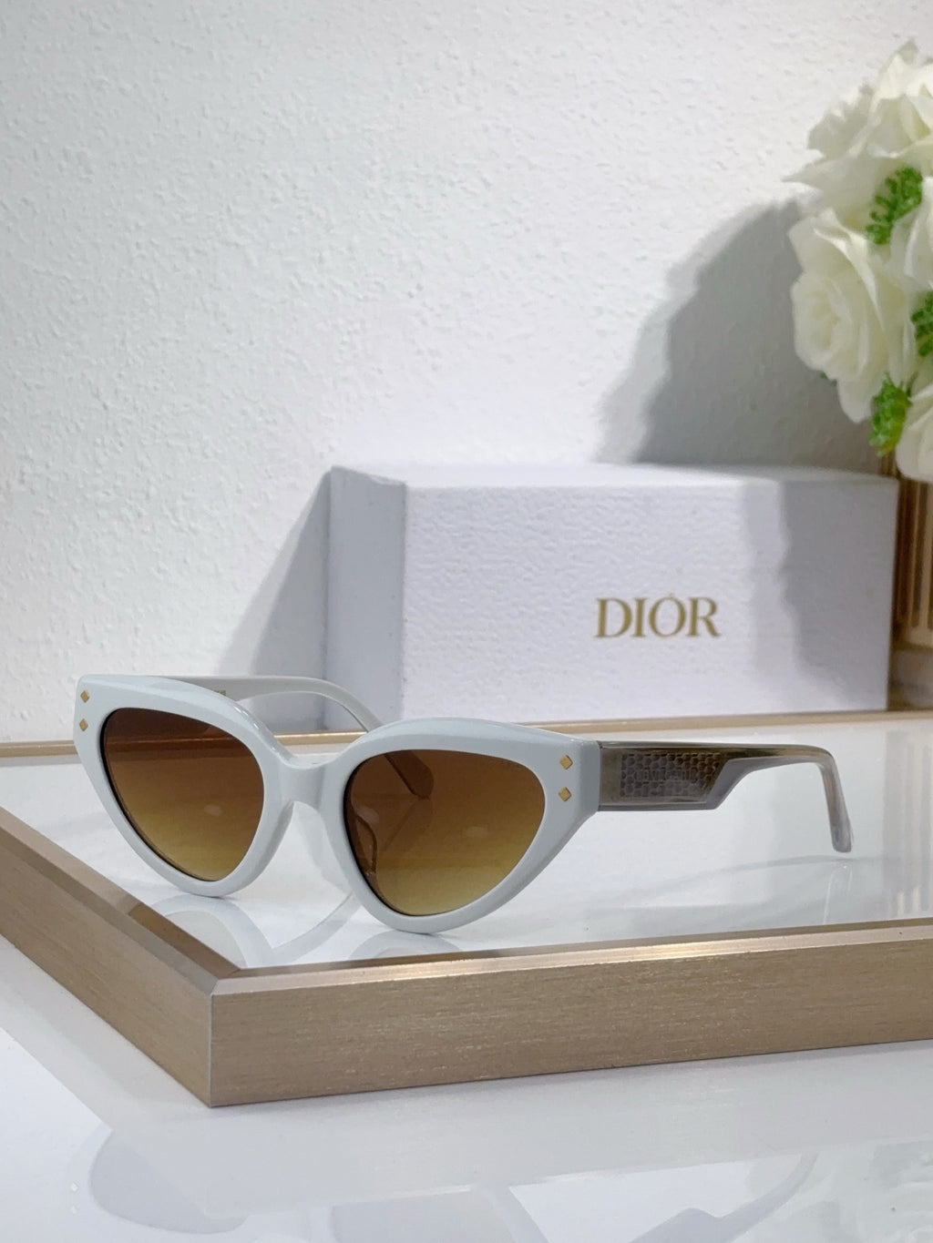 Bvlgari cat-eye sunglasses with white frames and amber-tinted lenses
