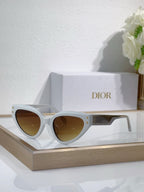Bvlgari cat-eye sunglasses with white frames and amber-tinted lenses