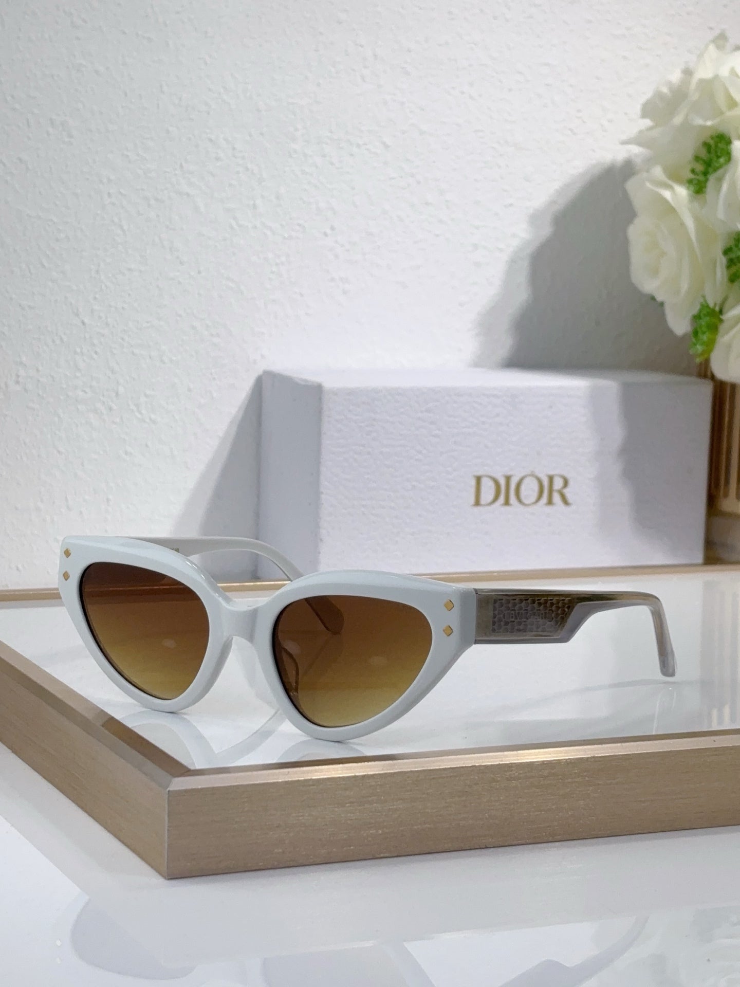 Bvlgari cat-eye sunglasses with white frames and amber-tinted lenses