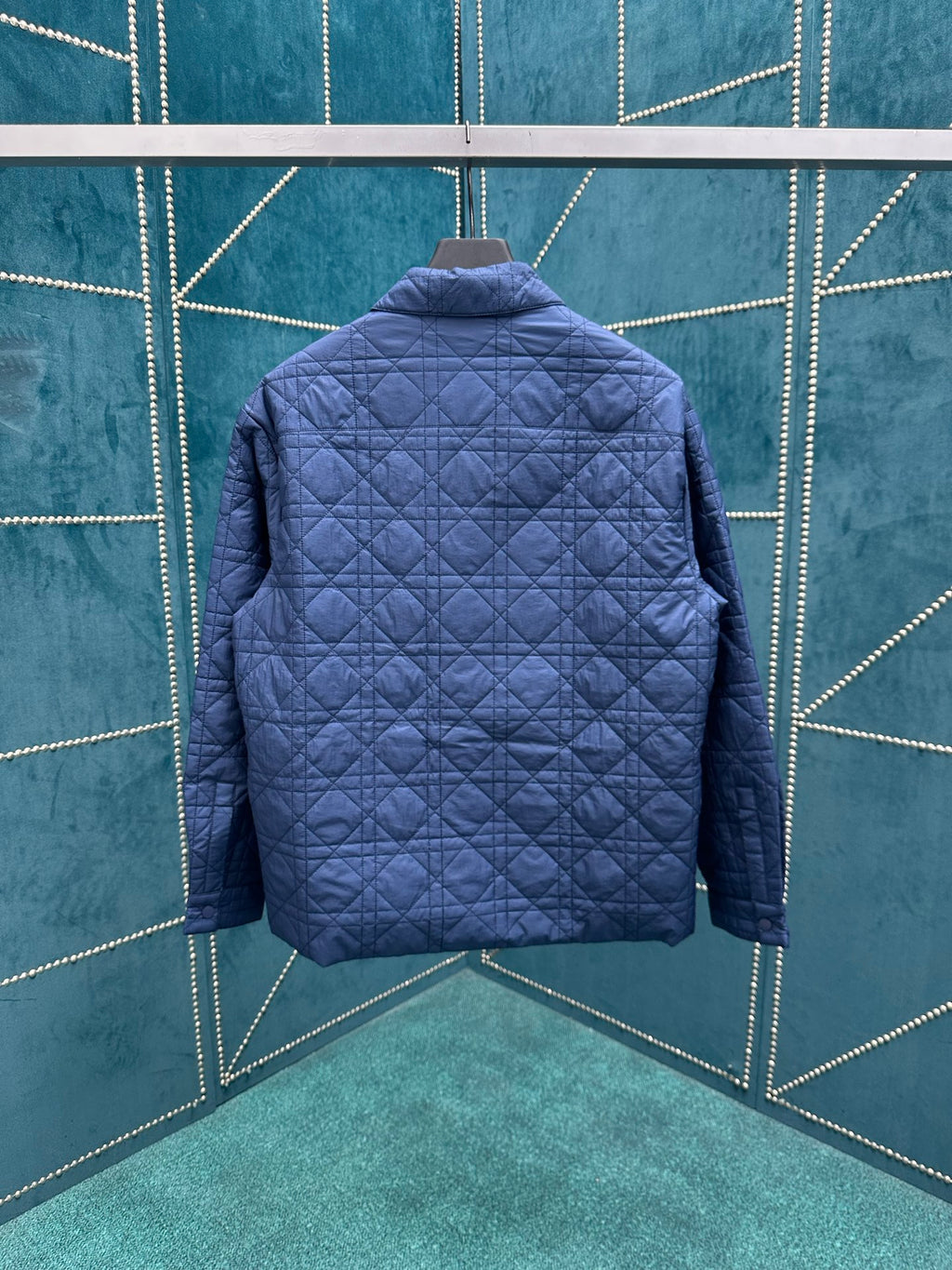 Navy quilted jacket with stand collar, back view