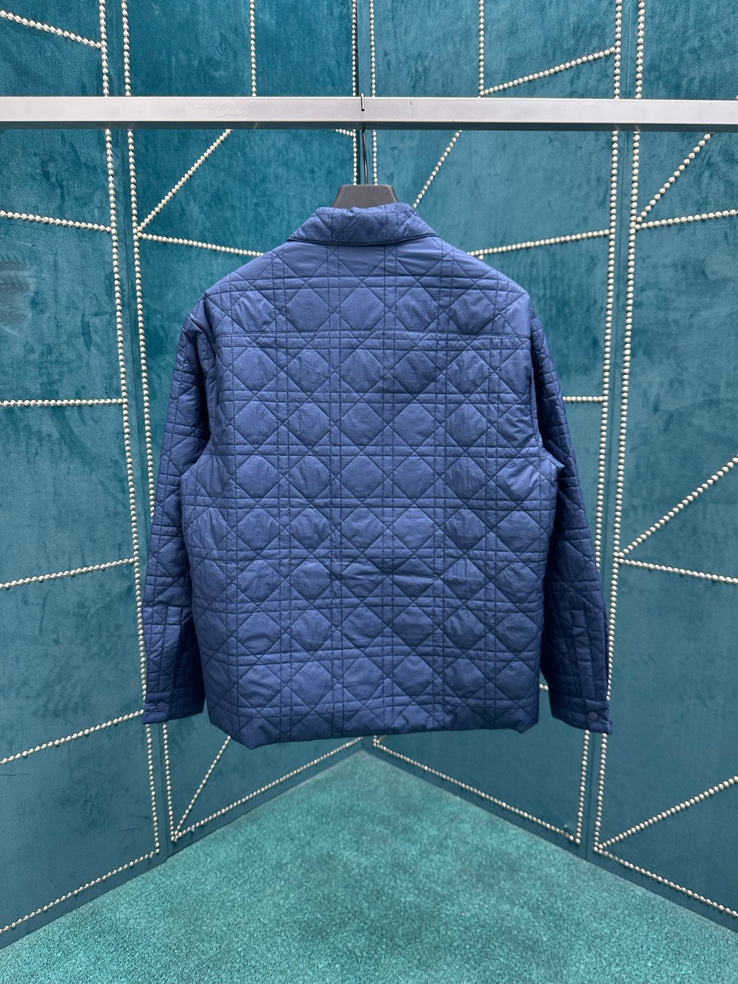 Navy quilted jacket with stand collar, back view