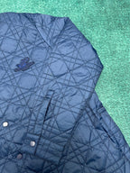 Navy quilted jacket with button placket and embroidered logo patch