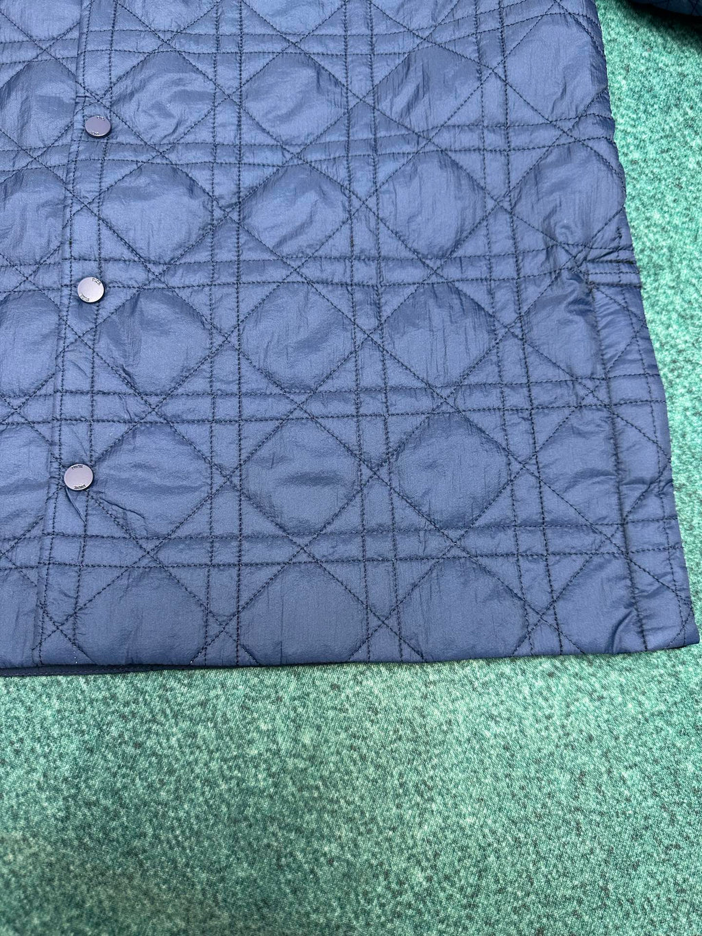 Navy quilted jacket with snap-button front and diamond stitching