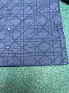 Navy quilted jacket with snap-button front and diamond stitching