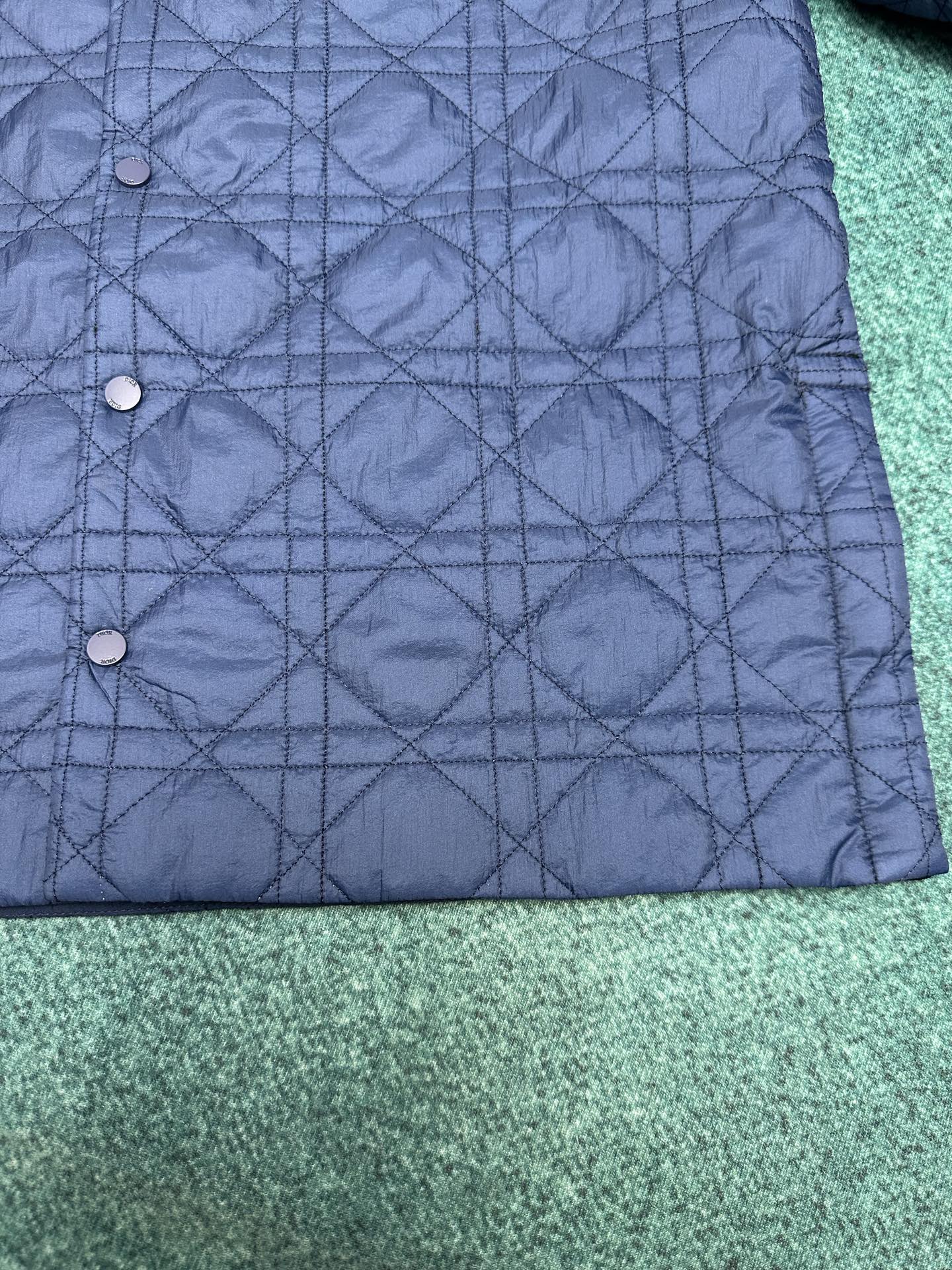 Navy quilted jacket with snap-button front and diamond stitching