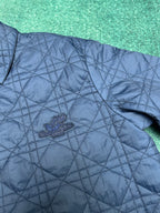Navy quilted jacket front with small crest logo on chest