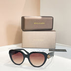 Bvlgari round sunglasses with dark red-brown lenses and black frames