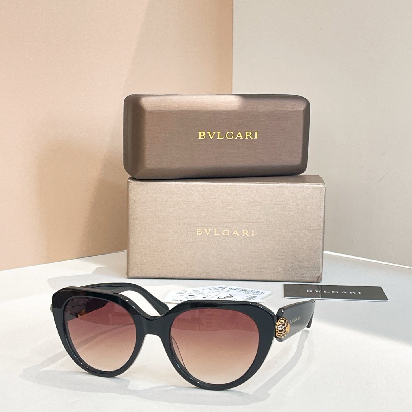 Bvlgari round sunglasses with dark red-brown lenses and black frames