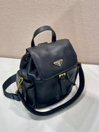 Prada dark blue mini backpack with flap, top handle, and adjustable shoulder strap