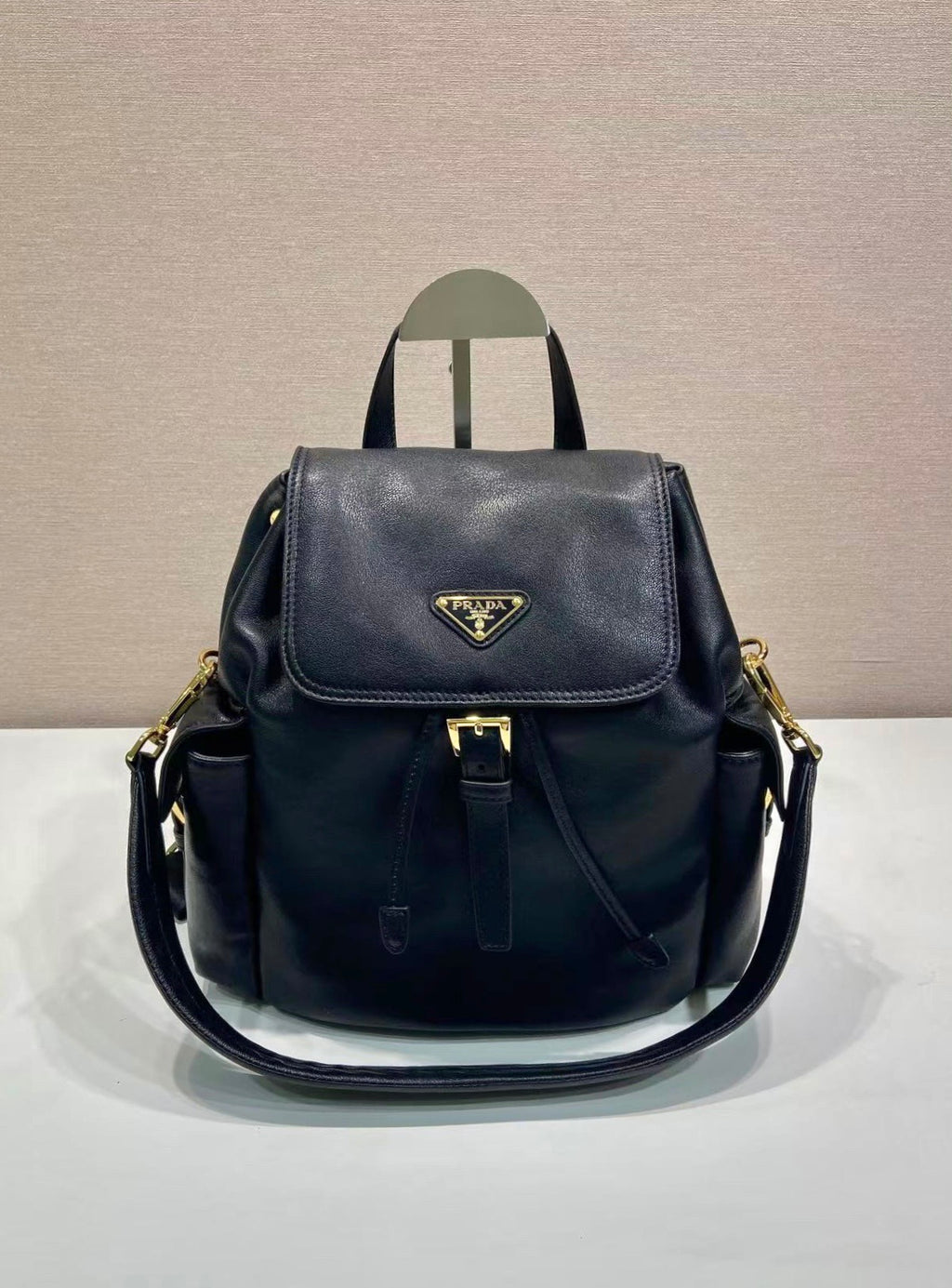 Prada dark blue leather mini backpack with front flap and gold-tone hardware