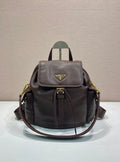 Leather mini backpack with flap front, gold-tone logo, and adjustable shoulder straps