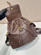 Brown leather mini backpack with drawstring detail and front flap pocket