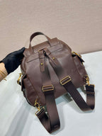 Brown leather mini backpack with two front buckles and adjustable crossbody straps